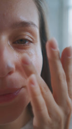 white woman applying bearpo brightening eye cream while massaging the eye area to reduce puffiness and dark circle